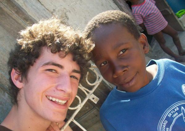 Fuller Center volunteer making a new friend in Haiti